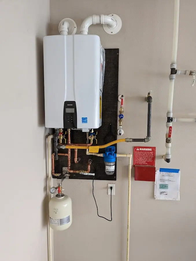 Professional plumber installing copper piping in a Butler home